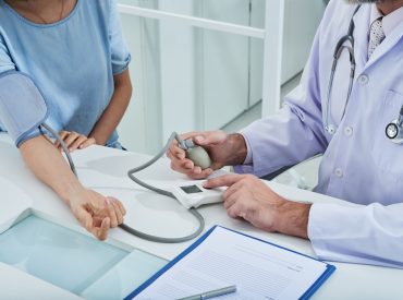 anonymous-doctor-measuring-blood-pressure-unrecognizable-patient-with-tonometer_1098-19336