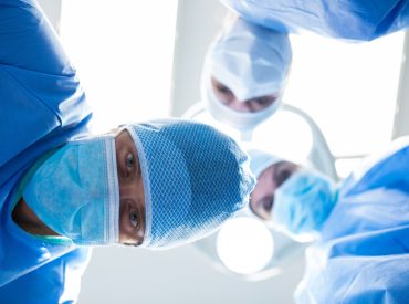 surgeons-looking-camera-operation-room_1170-2262